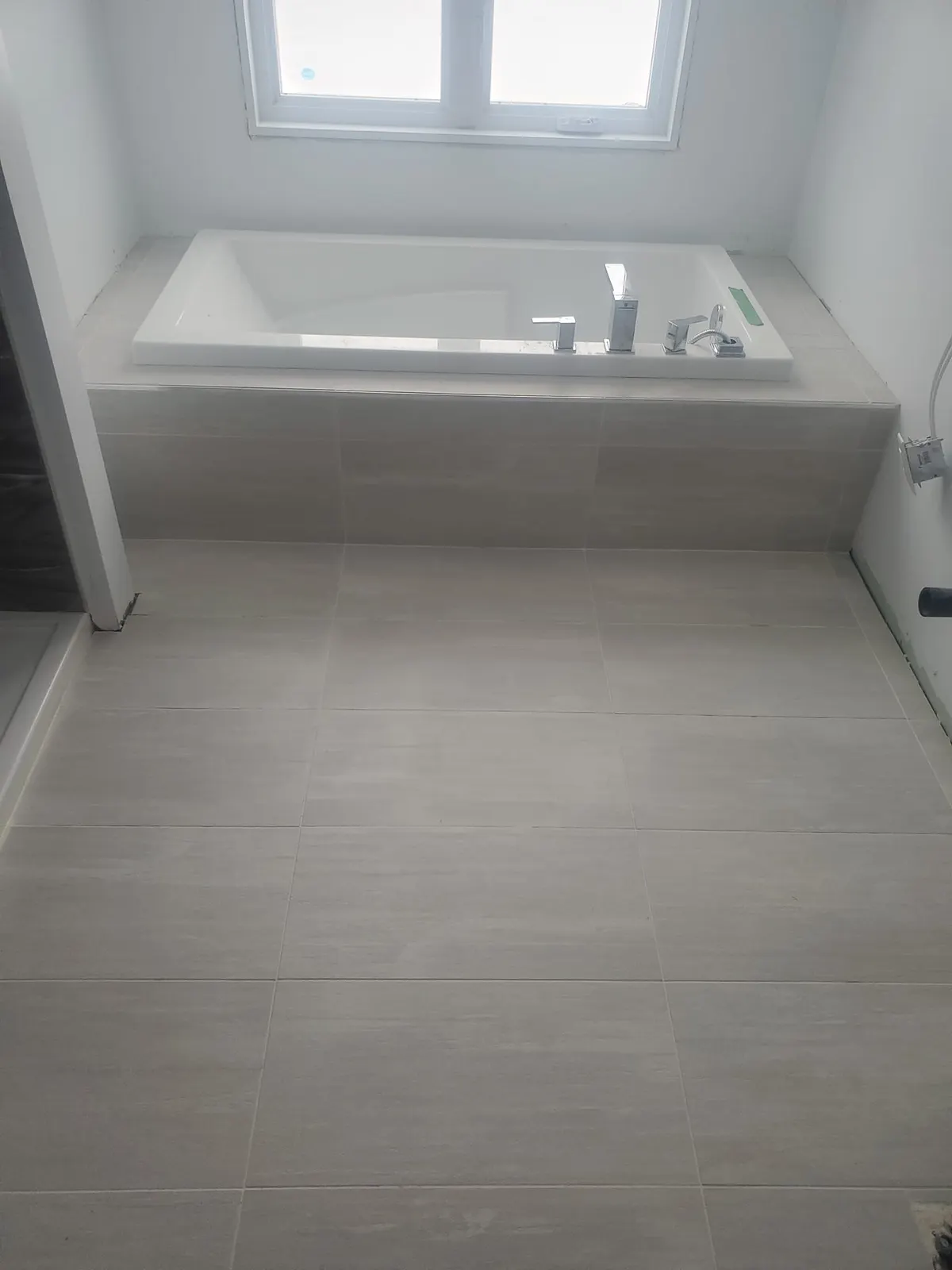 Salle de bain en chantier : bain sur podium de céramique