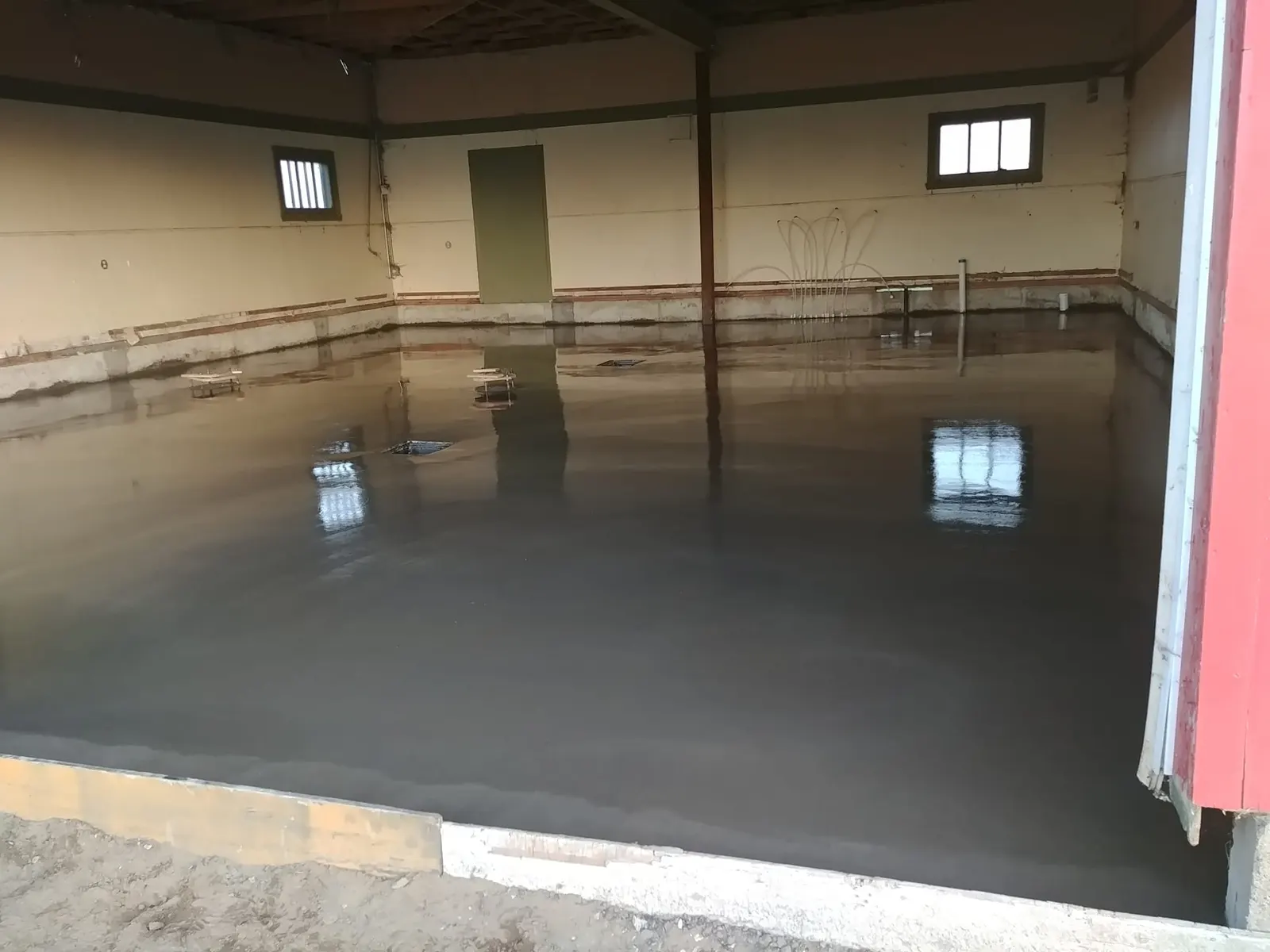 Plancher de béton lissé, encore humide, dans un bâtiment