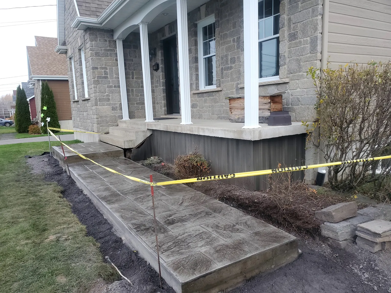 Trottoir en béton estampé fraîchement coulé devant une maison